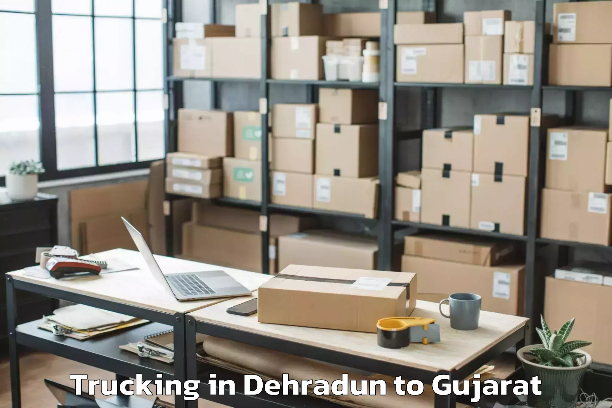 Book Your Dehradun to Mendarda Trucking Today